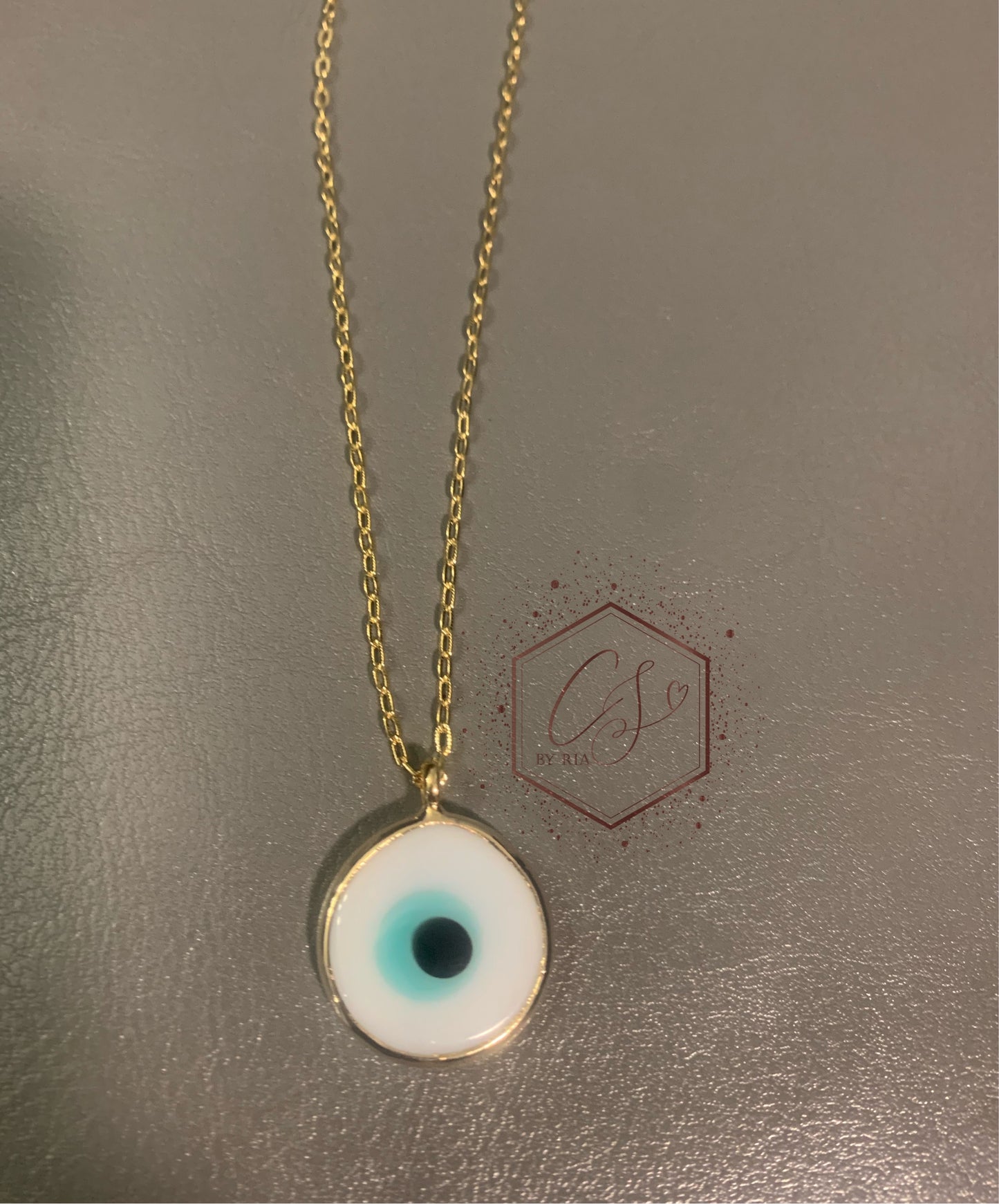 White and teal round evil eye necklace